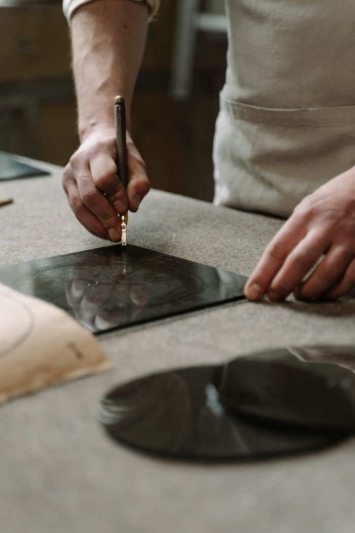 services-img Skillful artisan cutting glass sheet by hand, showcasing craftsmanship in a workshop setting.
